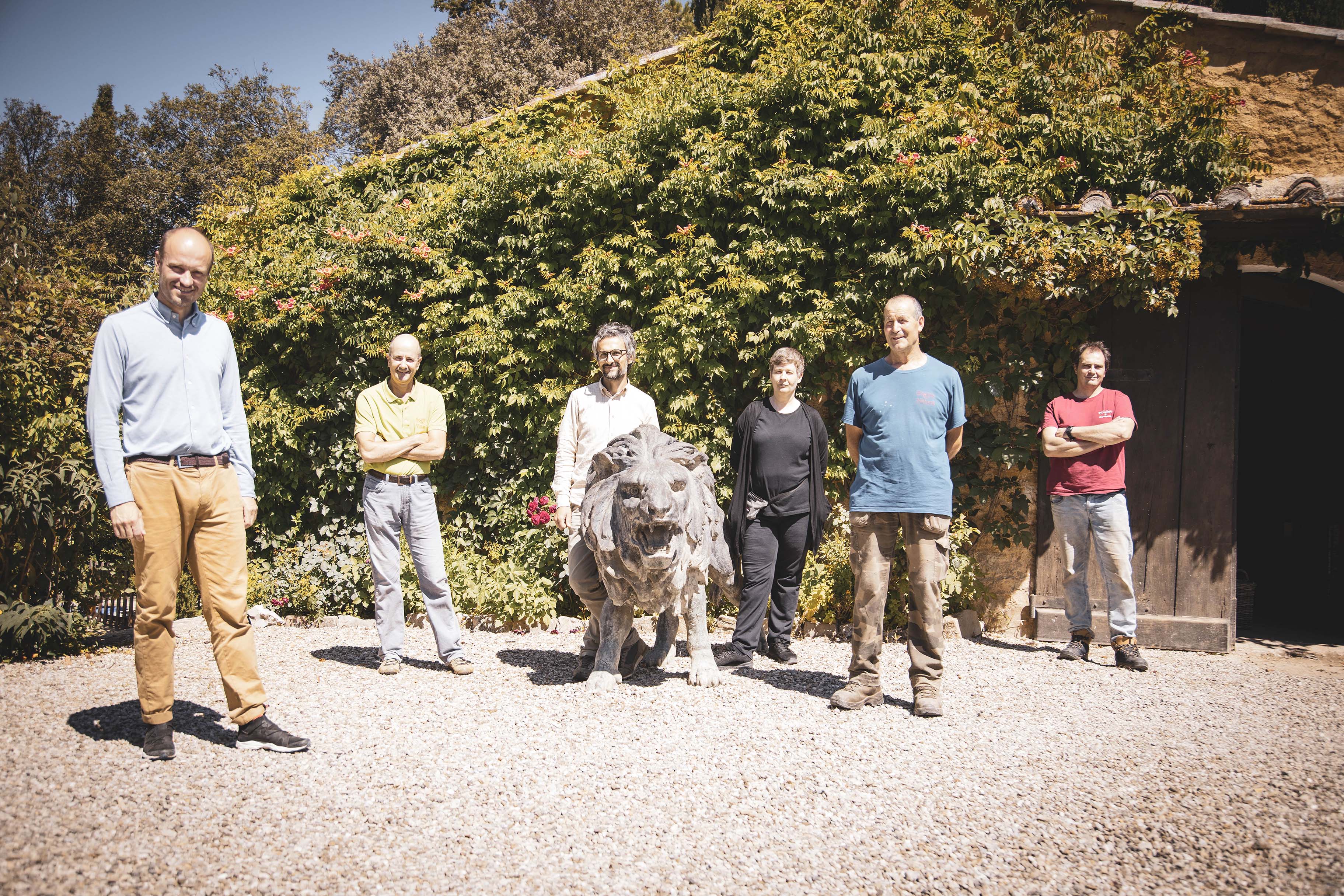 die Familie Nittardi vor einer schönen alten Scheune mit einem Steinlöwen